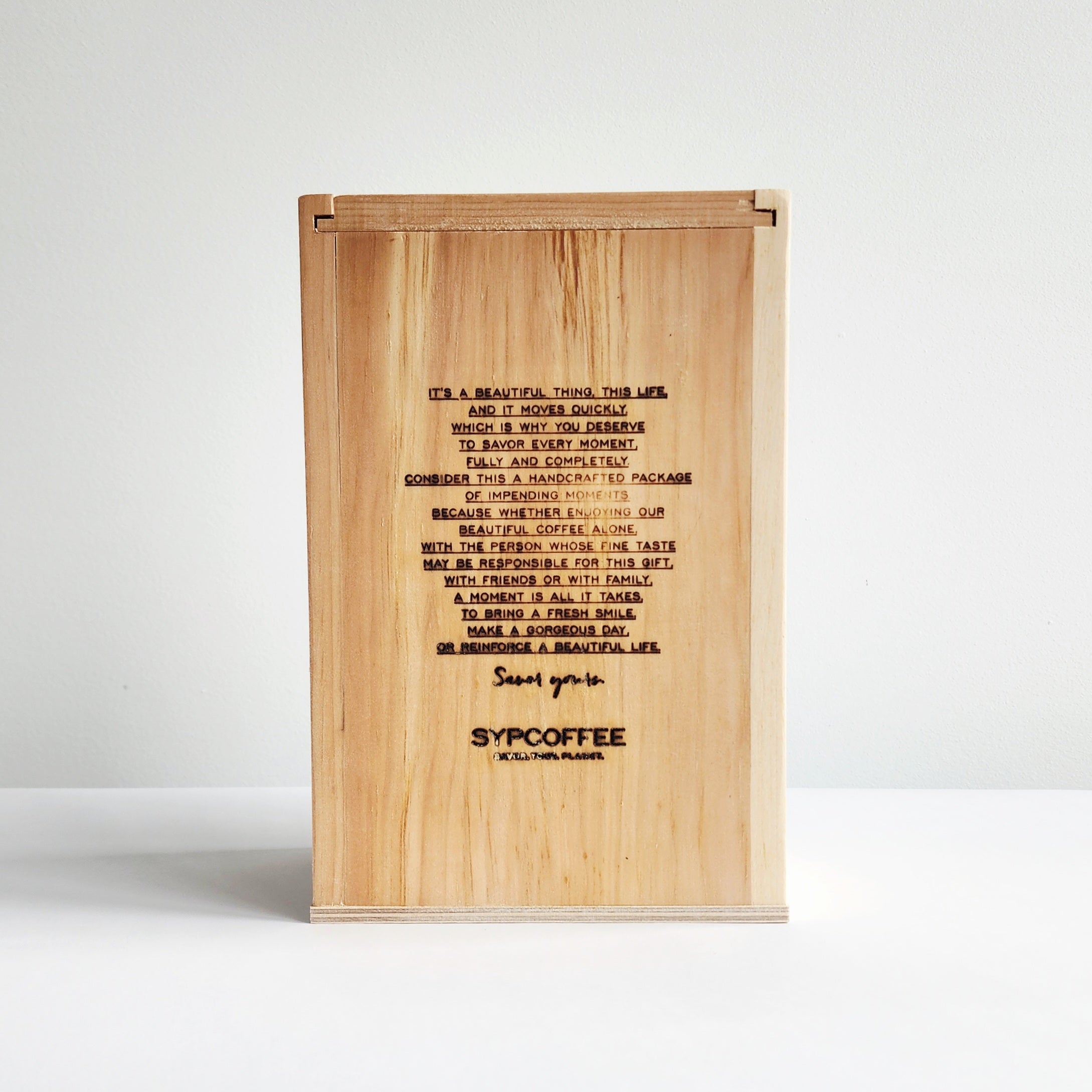 Wood SYPCOFFEE Box with engraved manifesto on a white background